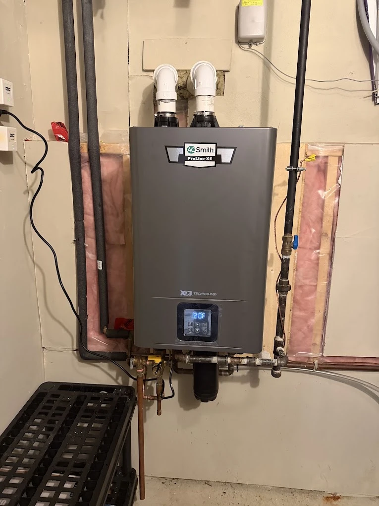 Wall-mounted tankless water heater with copper water lines and a gas line run neatly to it.